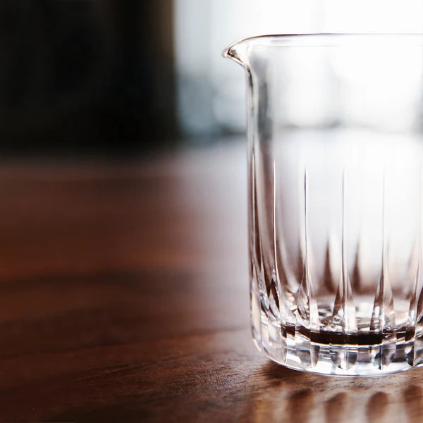 Cocktail Kingdom Seamless Paddle Mixing Glass Tapered Base shown clear on wooden table.