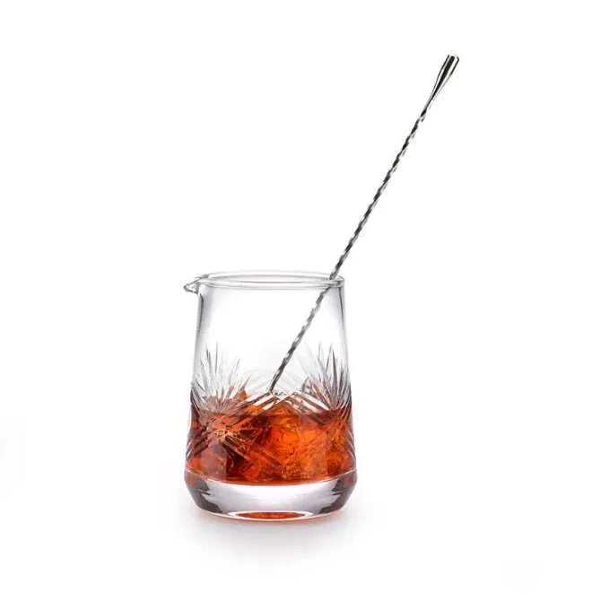 Barfly Wide Base Mixing Glass 25 ounces / 740 ml shown filled with liquid being stirred by barspoon on white silo background.