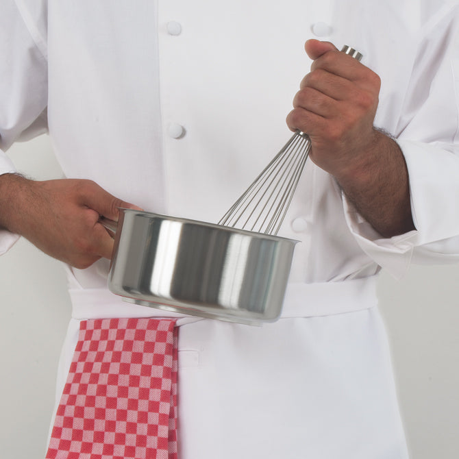 Professional Chef whisking in pot with Checkered Kitchen Towel by JB Prince in red shot on white silo background.