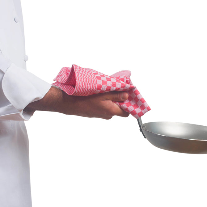 Professional Chef holding hot pan with red Kitchen Towel By JB Prince on white silo background.