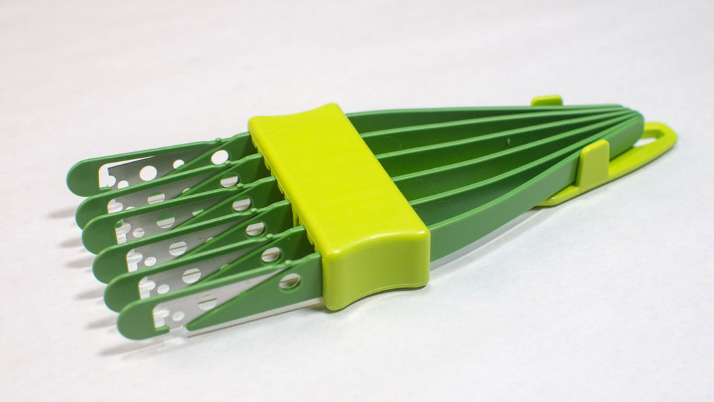 light and dark green 6 blade bread lame or bread scorer with the protectors on the blades