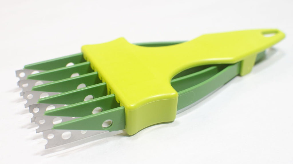 Light and dark green 6 blade bread lame or bread scorer with the blade protectors taken off. 