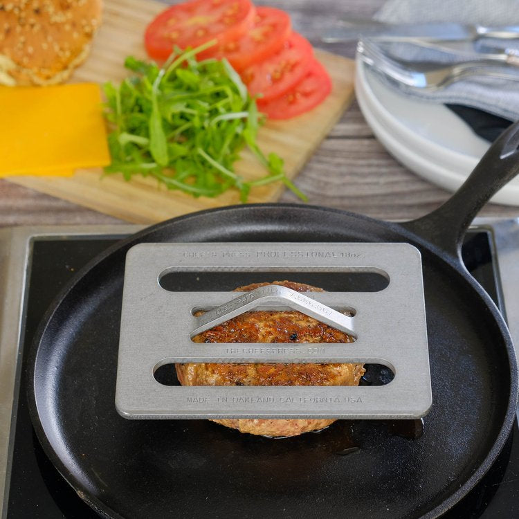 Hamburger Chef press on a pan with ingredients in the background