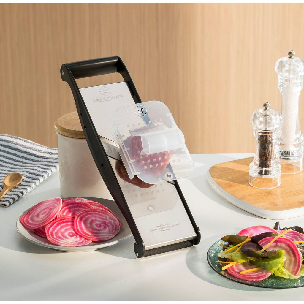 Vegetable slicer with sliced beets on a kitchen counter