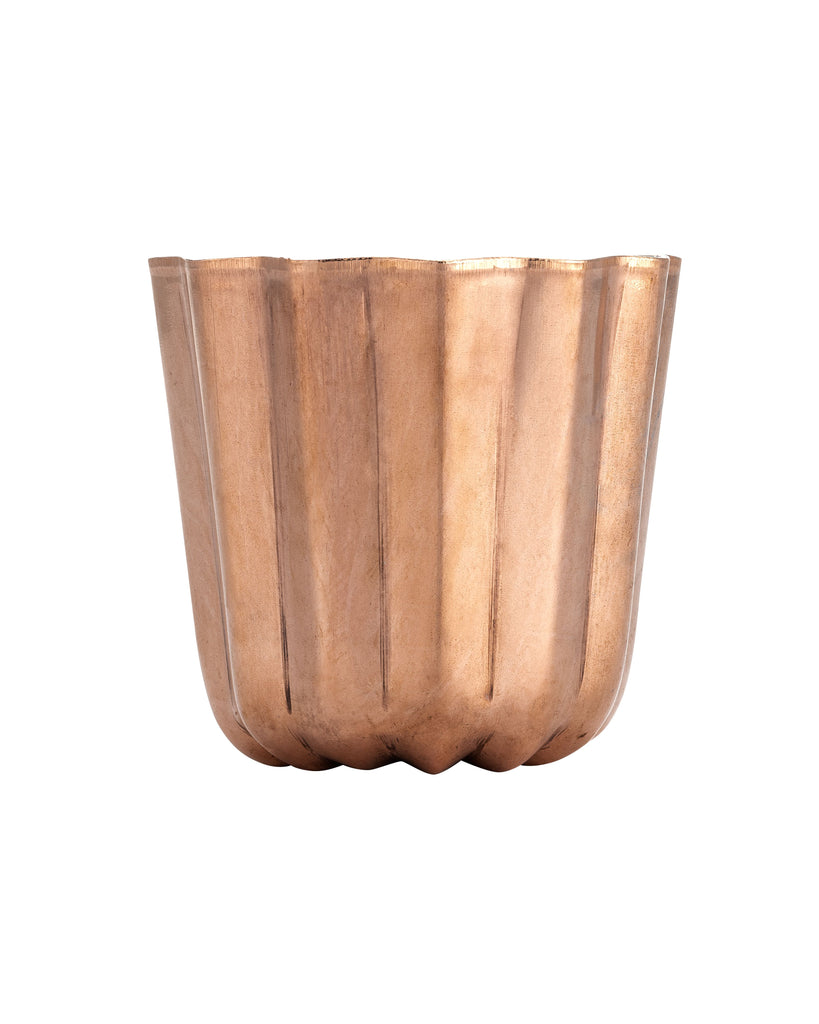 Copper colored tin mold on white background. 