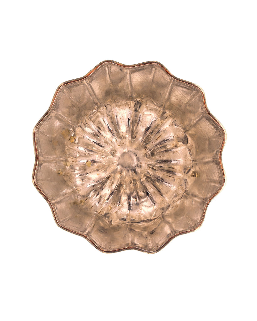 Above view of Copper colored tin mold on white background.