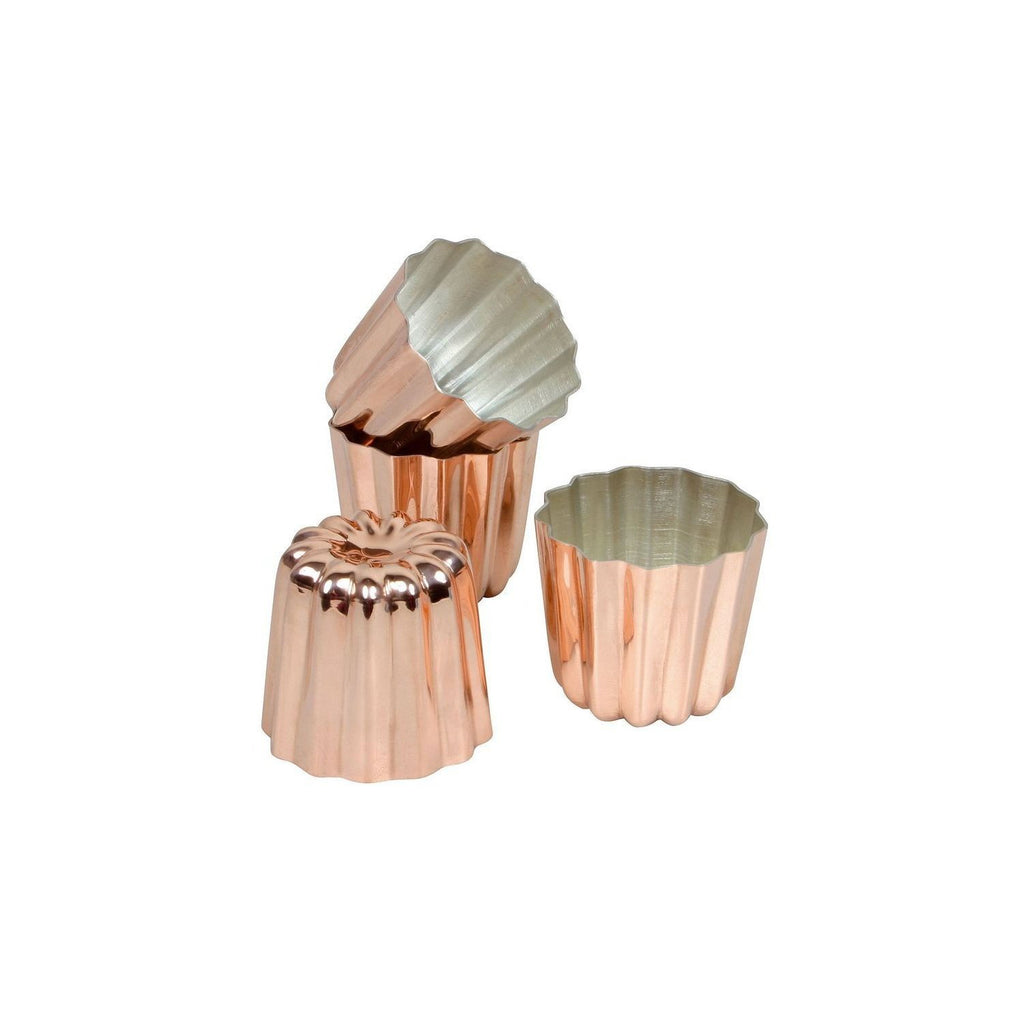 Set of four copper canele tins on a white background