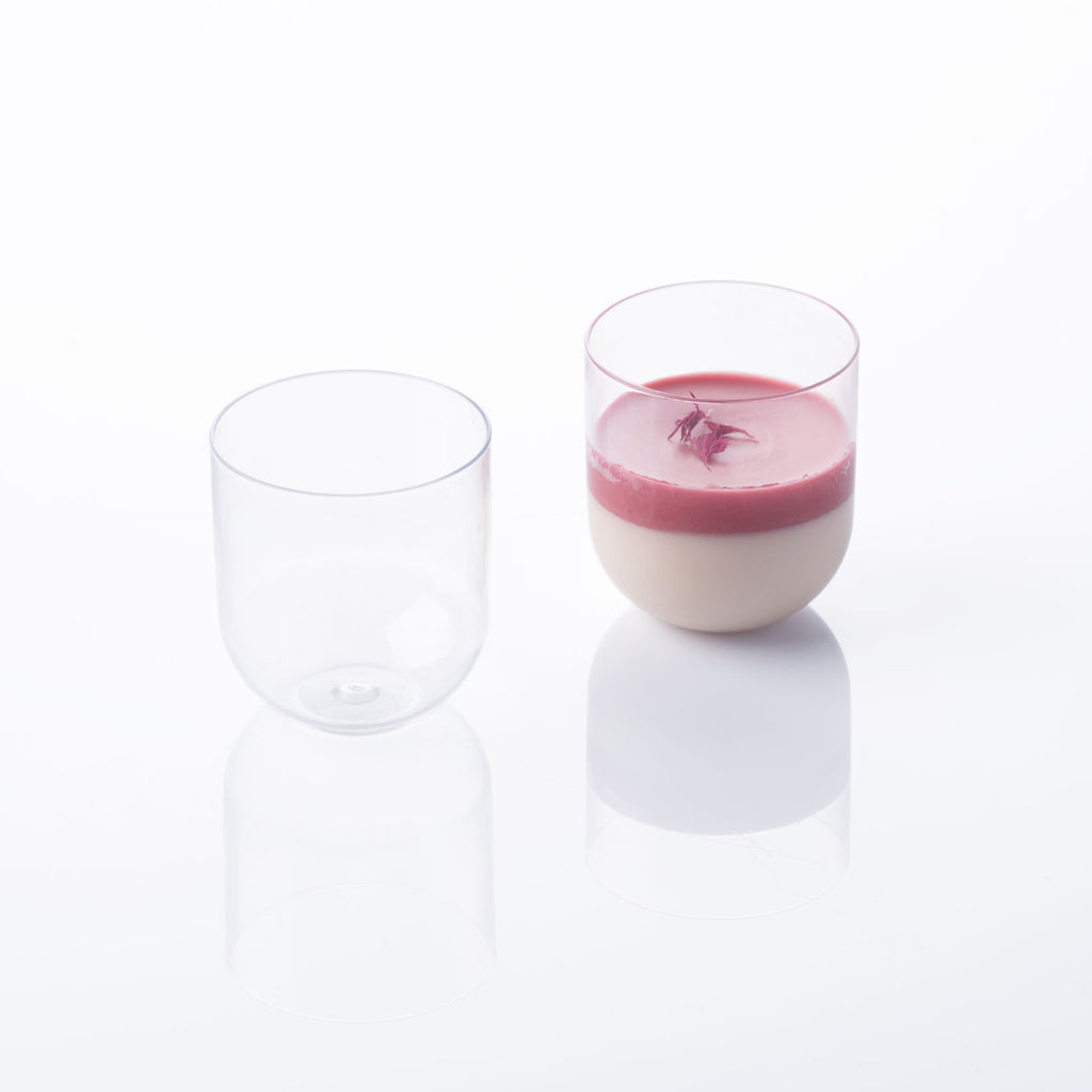 2 Plastic Tumblers, showing one empty and one full of a white pink pastry. Shot on a white silo background.