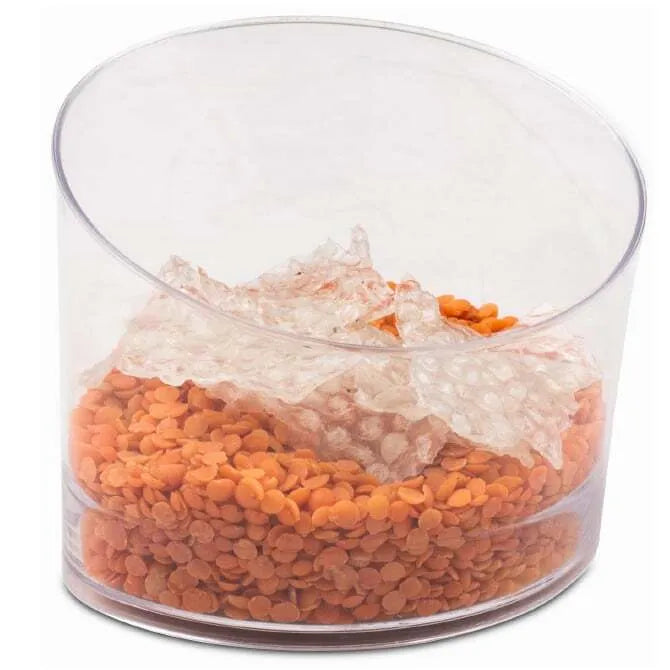 Angled Oval Glass 6.42oz shot on white silo background and garnished with orange seeds.