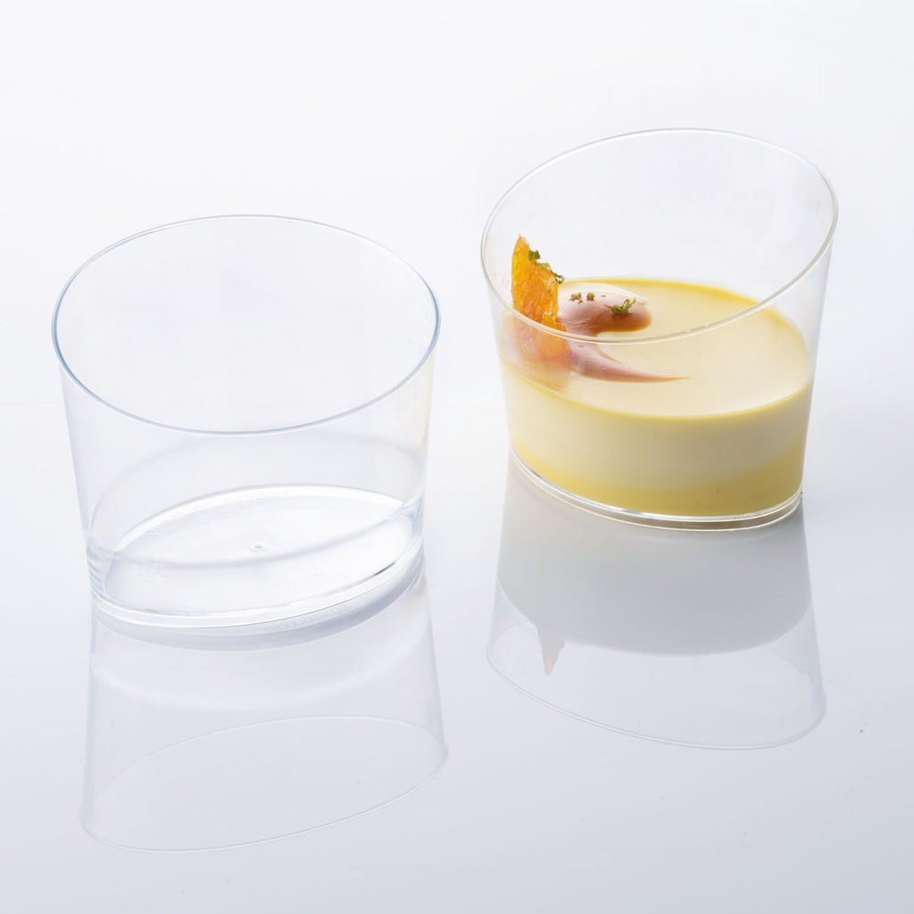 2 Angled Oval Glasses 6.42oz showing one empty and one with yellow pastry shot on white silo background.