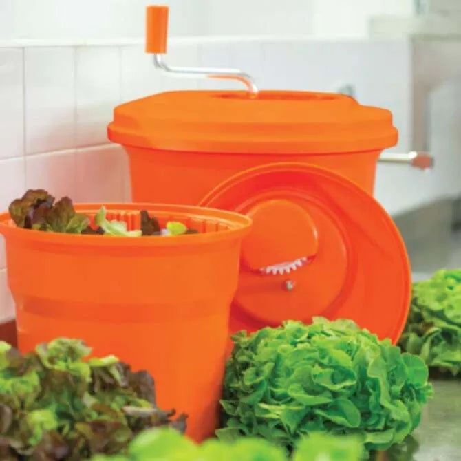 U610 U750 Manual Salad Spinners together with green leafy heads of lettuce around and inside spinners with white tile background.