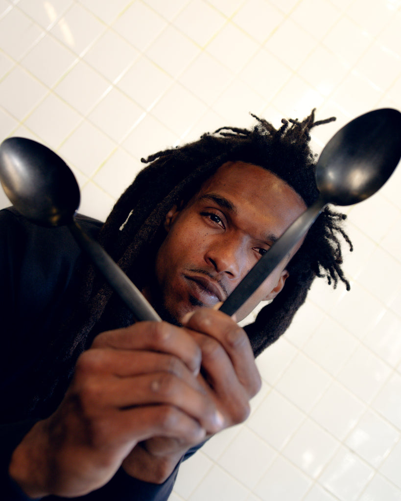 Gray Kunz Spoon: JB Prince x Tilit Edition hand held by street artist.