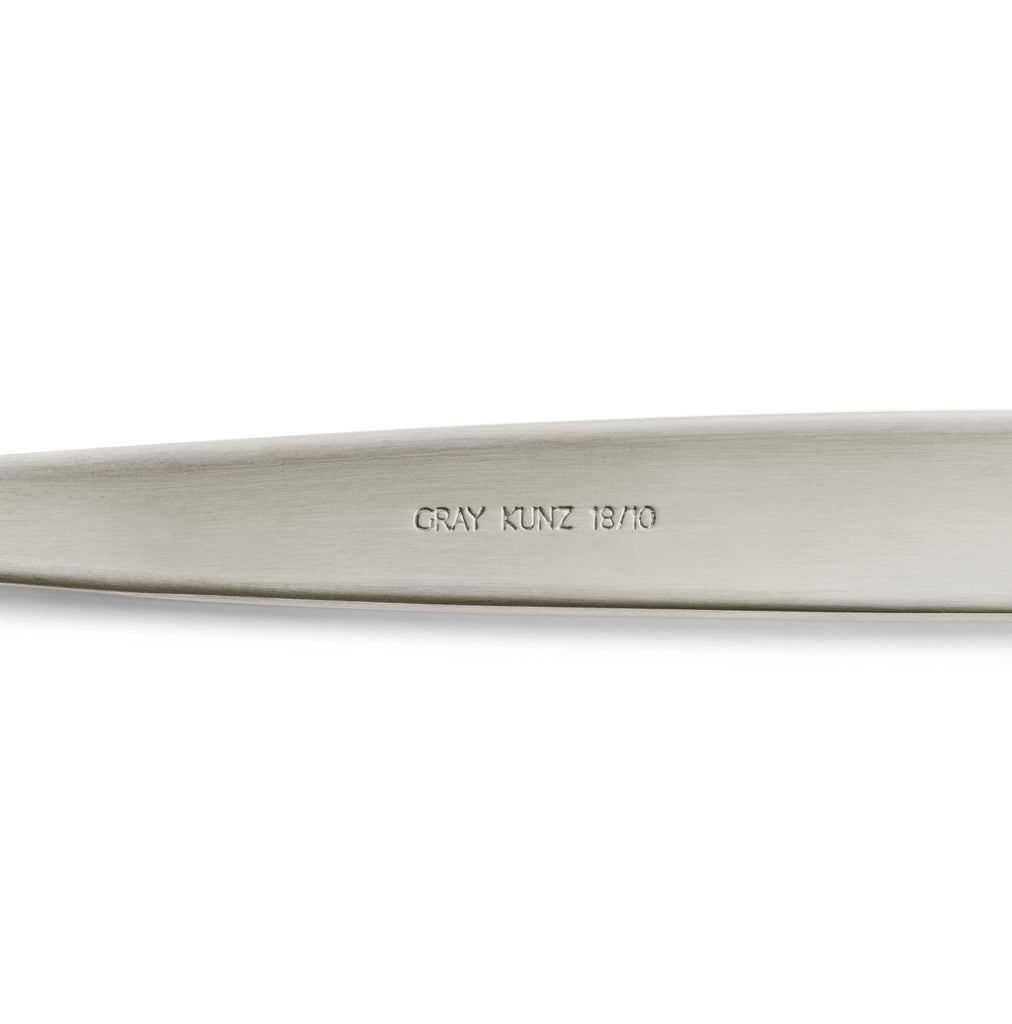 Silver JB Prince Gray Kunz Sauce Spoon in Original size showcasing Gray Kunz Logo 18/10 on underside of spoon.