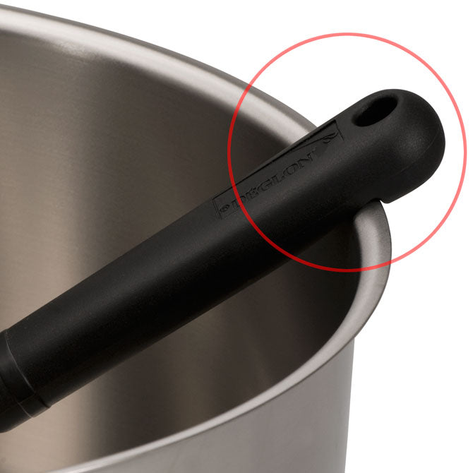 Utility Spoon with  Notched Handle Zoomed in on and Highlighted within cooking pot.