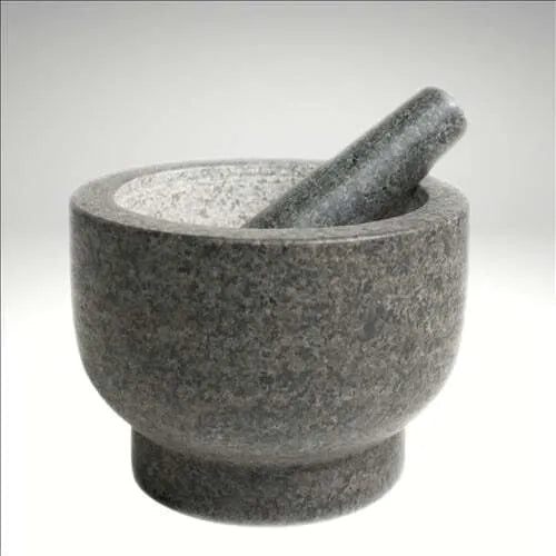 A solid uncoated granite mortar and pestle with a rough interior, tall walls, and natural color variations.