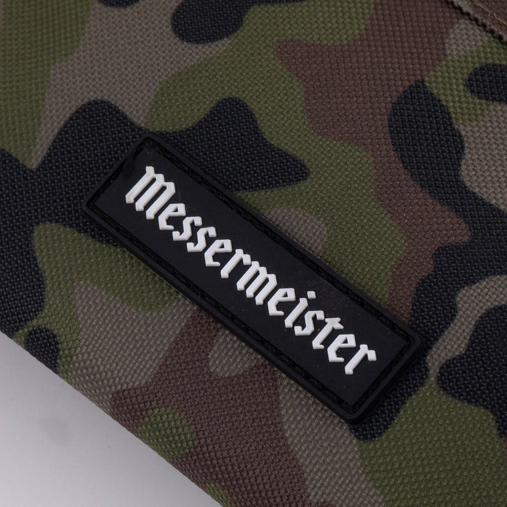 Black 'Messermeister' logo on a camouflage knife carrier bag background.