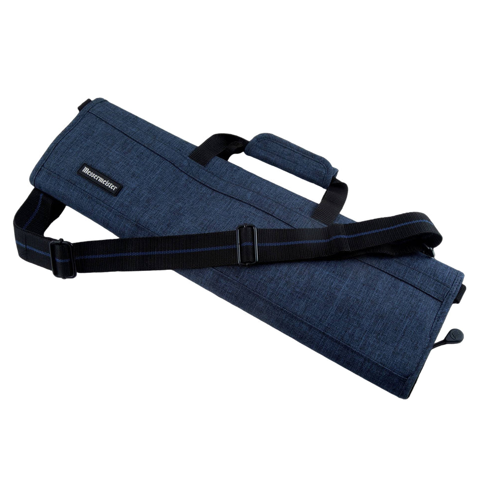 Navy Blue fabric knife roll with black strap on a white background.