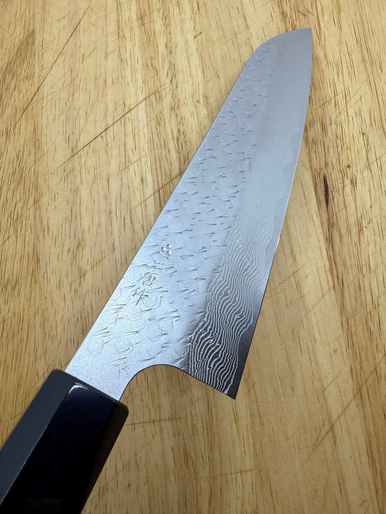 Z550 Nigara SG Strix Gyuto 210mm showing blade on brown wooden cutting board.